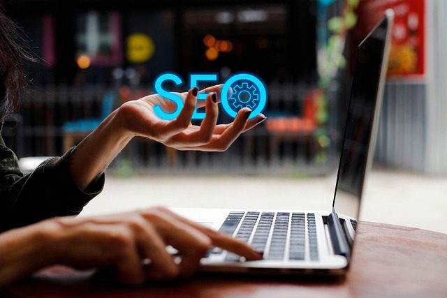 Woman holding SEO sign while on Computer