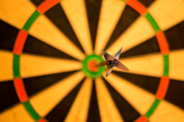 Darts board with dart in center